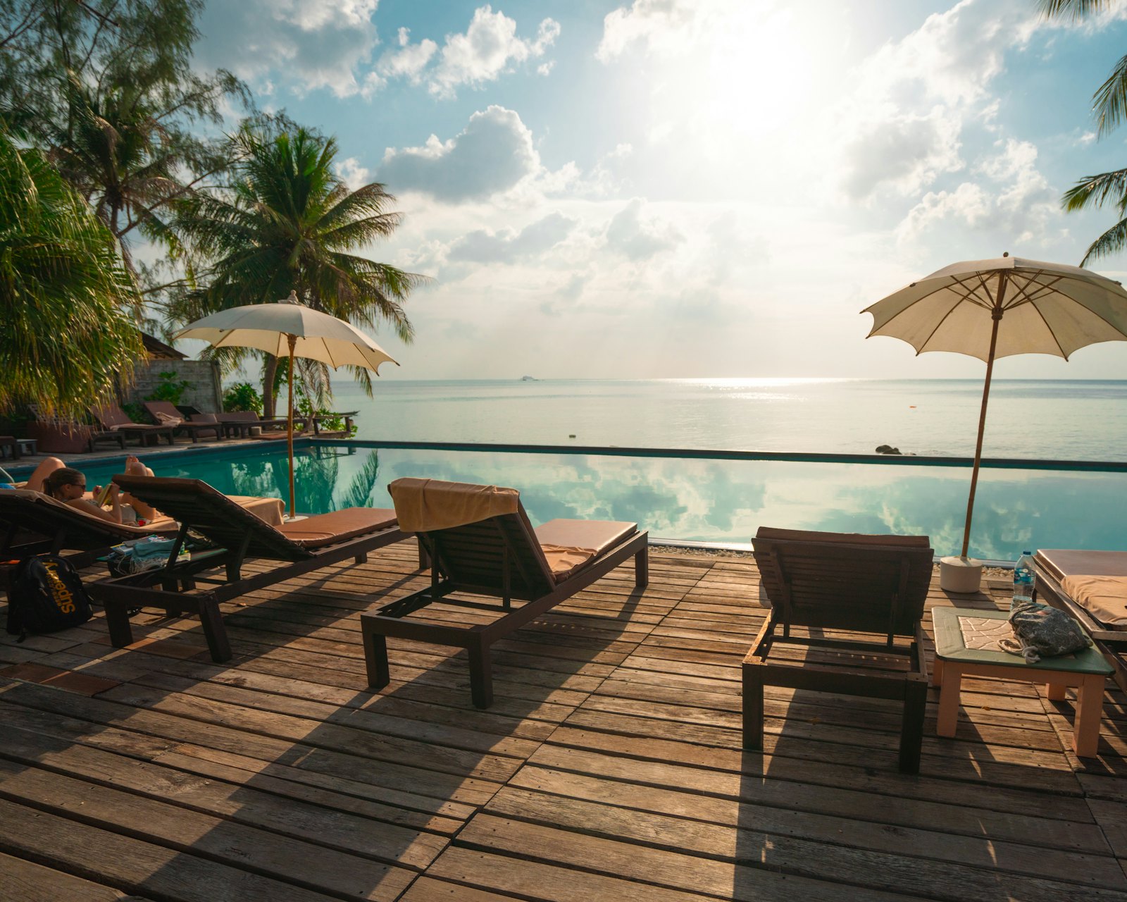 Corina Suites poolside loungers by the sea